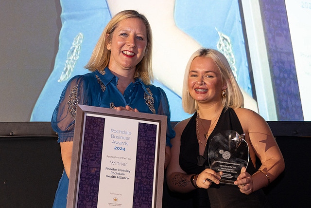 Phoebe Crossley from Rochdale Healthcare Alliance, receiving her trophy for Apprentice of the Year from Julia Heap, principal at Hopwood Hall College