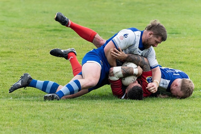 Travis Long gets stuck into his defensive duties