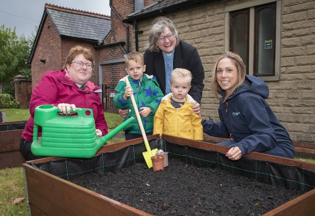 People of all ages are helping with the community garden.