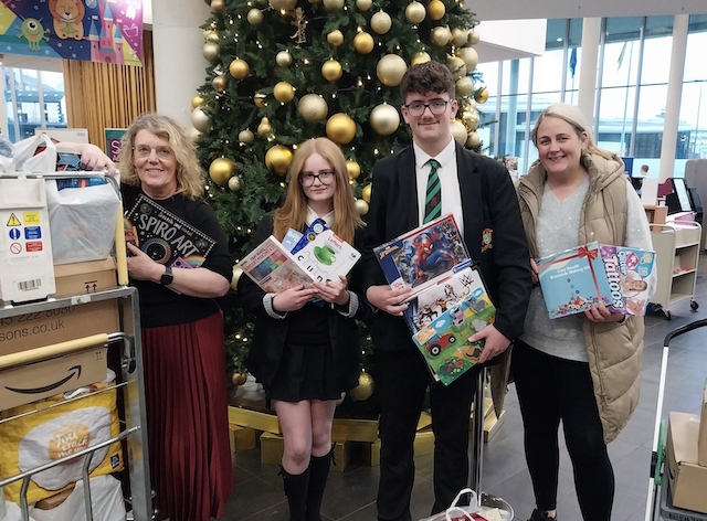 Helen Walton from the Rochdale Giving Back Christmas Toy Appeal with Cardinal Langley School pupils Oliver and Lucy