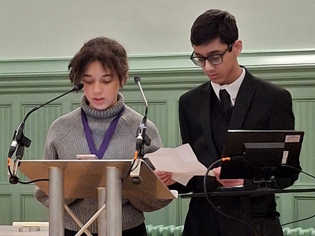 Sarah Orakwue and Hussain Malik, members of the UK Youth Parliament read a poem about Auschwitz