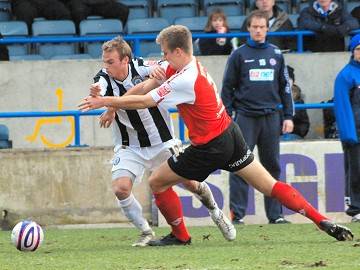 Touchline grapple: Kallum Higginbotham takes on his marker