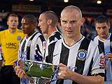 Gary Jones lifts the Rose Bowl after Rochdale's win