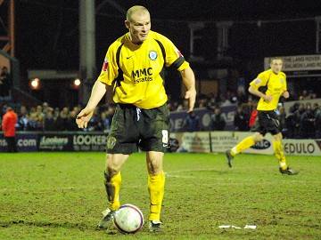 Searching skipper: Gary Jones looks for a pass on his 347th appearance for Rochdale