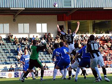 Rory McArdle tries to get his head on a Rochdale corner