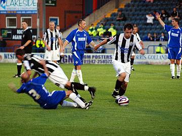 Kallum Higginbotham wins the ball off Alan Wright and Dagnall takes it up en route to his goal