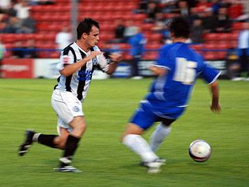 Dagnall skips past Stefan Stam in the build up to his goal