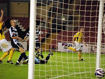 In the net - Prendergast wheels away as his finish enters the goal