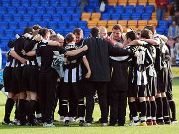 The Dale players celebrate the win in a huddle