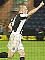 Gary Jones wheels away in celebration after scoring the winning penalty