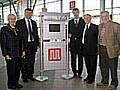 Transport Minister Derek Twigg unveils a plaque to commemorate the opening of the new bus station