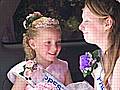 One of the youngest carnival queens enjoys the parade in the sun