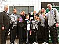 Iain Johnstone, Business Development Manager at Rochdale FC, Councillor Wera Hobhouse and several players from Rochdale FC