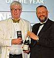 Paul Rowen receives his award and champagne from Howard Johnston, Editor-in-Chief of Tramways & Urban Transit.