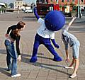 The PCT mascot exercises with visitors to the event