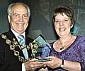 Lynn Byrne, a library assistant is presented with her trophy by then Mayor, Councillor Robin Parker at last year's award ceremony.