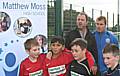 Rochdale manager Keith Hill and assistant Dave Flitcroft with young footballers from Siddal Moor Primary School at the opening of the new astroturf at Matthew Moss.