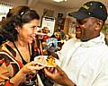 Manchester's Celebrity chef Mike Hylton offers Blanca Aydin a taste of Caribbean cooking at Celebrating Diversity, organised by Bowlee Park Housing.