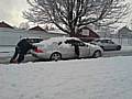 A family are forced to push their car up Bentley Street.