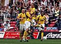 Rochdale players and fans celebrate Chris Dagnall's equaliser