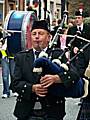 A member of the Oldham pipe band starts up a tune during last year's parade.