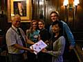 European summer campers present President Norman Wellens with a banner commemorating their visit to Middleton Rotary.