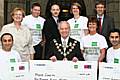 A welcome donation: Christine Webb, Chief Executive of Springhill Hospice (back left) and Mayor Councillor Robin Parker receive cheques from Impact athletes Nigel Muirhead, Zak al-Hassani, Zoe Banister, Eileen Jorgensen, Steve Woods, Aky Hussein and Amir Zia.