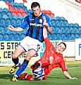 Rory McArdle is tackled by Accrington's Sean McConville.