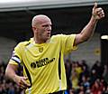 Branston gives a thumbs up to the Rochdale supporters as they praise his man-of-the-match performance.