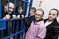 PC Rob Smiths in the cells with Elmwood pupils looking on and PCSO Dominique Grimes. 
