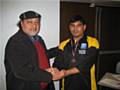 Abdur Rehman receives his man of the match award from Empire's Mr Tufail.