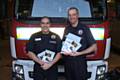 Firefighters Kris Ahmed and Chris Robinson with 'safe for winter' Christmas cards and posters.