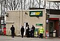 Police officers investigating the scene at the petrol station on Newhey Road.