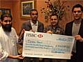 Islamic Relief representative along with the Deen For All team and Adam of Karim's Restaurant with a cheque for the final total raised. 