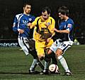 Dagnall tries to force his way between Montrose and Hall.