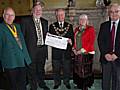 The Mayor is presented with a £700 cheque raised at the Nutter's Lunch.