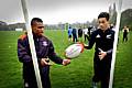 Kyle Eastmond shows camp participant Isaac Noi some techniques.