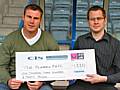 Rochdale Assistant Manager David Flitcroft receives the cheque from a Dale Trust representative