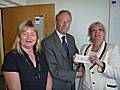 Martin Coupe presents his cheque to Kathy Thomas (left) and Vivien Carter from Rochdale Connections Trust.