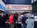 Shoppers stand outside the Wheatsheaf Centre following this afternoon's evacuation.