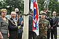 Servicemen and councillors join Mayor Keith Swift and Mayoress Sue Etchells to raise the flag.