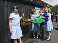 Smithy Bridge school children get their local train station ready for summer.