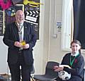 Rotarian John Kay presents the dictionaries to children at Redwood School.