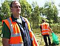 Community Payback Supervisor, Neil McLaren overseeing offenders working to tidy up on  Whitworth Road.