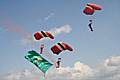 The Red Devils landing with the college flag