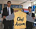 Year 10 pupils Viqas Bhatti (left) and Nazam Suleman at Falinge Park High School with their chef outfit