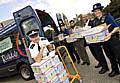 PCSOs Louise Cleary, Martin Smith and Chief Inspector George Fawcett with Sohail Ahmed and Arshad Mahmood from Rochdale Community Transport loading a van with the dates.