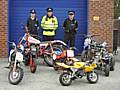 Police officers with the seized off road vehicles.