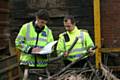 Officers look for stolen cable at a scrap yard