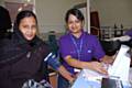 Health Trainer, Sabia Begum takes the blood pressure of a local resident